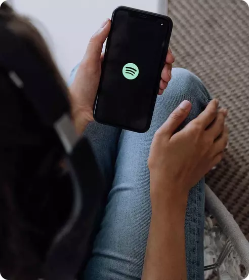 image showing a person opening spotify on their phone