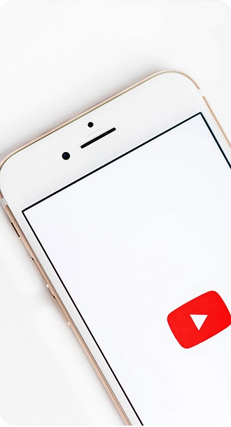 A smartphone displaying the YouTube app icon on a white screen.